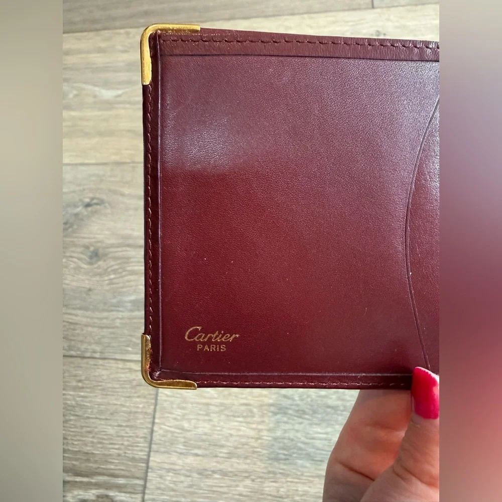 Cartier Men’s Deep Red Leather Bifold with Gold Corners